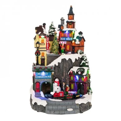XMAS LIGHTED VILLAGE WITH TOY SHOP, HOTEL AND ANIMATED TRAIN INCLUDING  ADAPTOR 22X22X35,5CM